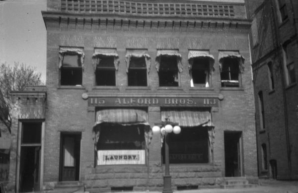 View from street looking towards the facade of the Alford Brothers Laundry located at 113-115 Carroll Street. This was a large business with twenty-five employees that supplied towel service to many businesses.