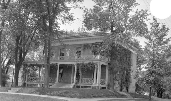 View from street of the home of James Ramsey at 302 S. Mills Street. The house was built by Seth Bergin, a farmer and real estate investor, in 1846 in the Italianate style, with a cupola. Dr. James Bowen, Madison's first homeopathic physician, lived in the house from 1859 to 1881. His daughter Susan Bowen Ramsey inherited the house, as did his grandson James Ramsey.