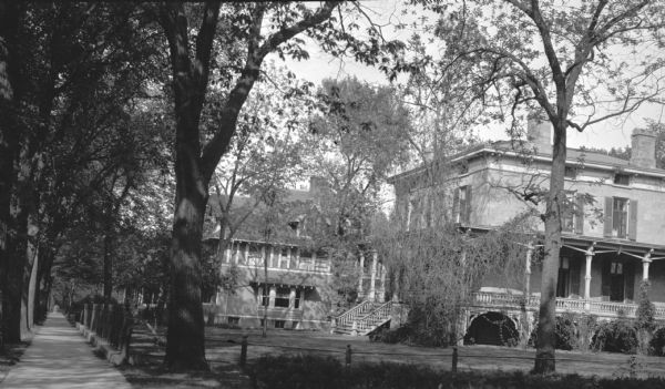 View from sidewalk of the Ford House with wrap-around porch. The Reverend F.F. Ford house, at 1023 Spaight Street, was built by Mr. Harris prior to 1875 when it was purchased by Storer. Winifred Ford, widow of Marcus Ford, lived here.