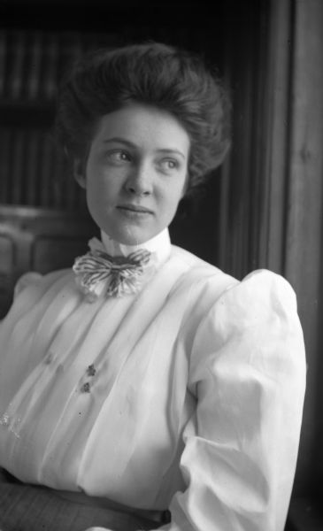 Waist-up portrait of Sybil Nash in a white blouse with puffy sleeves, and a striped tie. Sybil was a Hanks family friend.