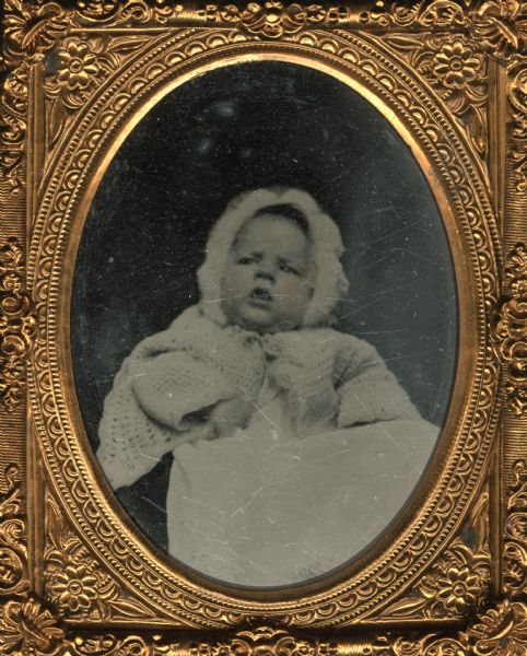 Ninth plate ferrotype/tintype of William Cowper Noyes as an infant. Son of William B. Noyes and Julia (Page) Noyes of Janesville. William died at the age of three from dysentery. Hand-coloring on the cheeks.