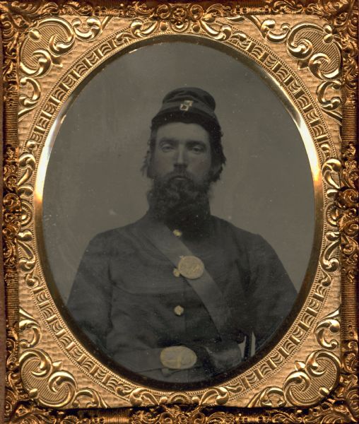 Waist-up ferrotype/tintype portrait of Jacob Learn, a Private in the Wisconsin 29th infantry, Company K. He enlisted in August 1862 and died on August 19th, 1862 of disease in Carrollton, Louisiana. Though they never met, Mr. Learn was also the uncle of Zona Gale. Hand-colored areas on face and uniform.