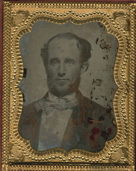 Ninth plate ambrotype. Quarter-length portrait of Alvin Rust, son of Theodore Rust. He is wearing a suit with a gingham bow tie.