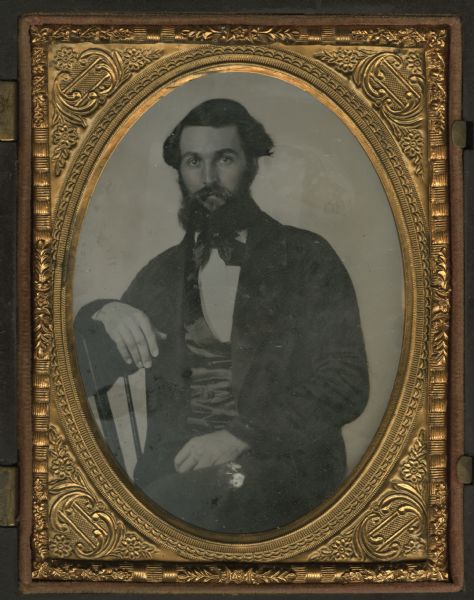 Quarter plate ambrotype portrait of Colonel Cyrus Marion Butt (b. 1833) of Viroqua. Col. Butt is seated sideways in a chair with one hand in his lap and one hand draped over the back of the chair. Col. Butt served in the Civil War with the Wisconsin 25th Infantry Regiment, Company A and later for the Wisconsin 48th Infantry Regiment, where he was promoted to major and later Lieutenant Colonel. After the war Butt returned to Viroqua and resumed a law practice.