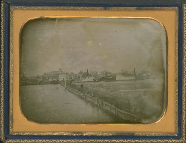 Half plate daguerreotype, with view across water of the Oshkosh, Wisconsin harbor showing the bridge over the Fox River. Moored on the opposite shore are the small steamboats <i>W.A. Knapp</i> and <i>Peytona</i>.