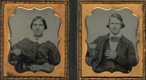A pair of sixth plate ambrotype waist-up portraits of an unidentified man and woman. In each portrait the subject is seated with the left hand on the lap and the right arm resting on a table holding a book. Each is holding the same book. Though unidentified the couple is most likely married.