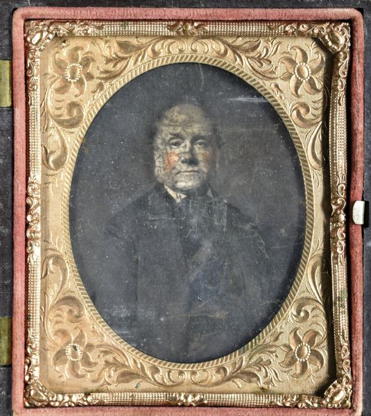 Sixth plate ambrotype of a quarter-length portrait of a man. Hand coloring on cheeks and lips.