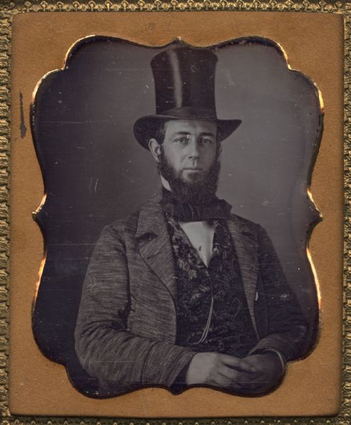 Sixth plate daguerreotype of Samuel Hunter Donnel. He is sitting with his hands in his lap and is wearing a formal suit with vest and top hat. Samuel Hunter Donnel was born in Pennsylvania and emigrated to Madison after marrying Rosellah M. Smith in 1854. He worked in partnership with August Kutzbock, a German-born and trained architect. It is presumed that Donnel was a draftsman and engineer. He died an untimely death in 1860 of lung disease.