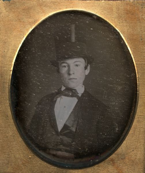 Sixth plate daguerreotype of Charles Krips. Charles Krips was the uncle of the donor of the portrait, Mrs. Julia Hicks. The portrait is a bust figure, facing forward with his head turned slightly to the left. He is wearing a tall hat. Hand-coloring on cheeks.
