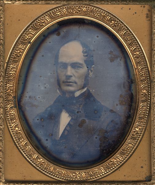 Sixth plate daguerreotype of John Bowman, a Madison Real Estate Agent, born in New York. John married Rosellah (Donnell) Bowman in 1863. The portrait is a front facing, bust figure with the subject turned slightly to the right. Hand-coloring on cheeks and lips.