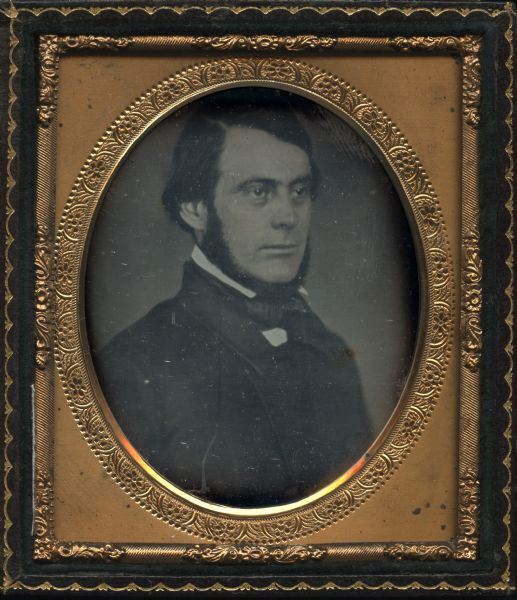 Sixth plate daguerreotype of Azel Parkhurst Ladd (1811-1854). Ladd was the Wisconsin state superintendent of public instruction in 1852. Oval-framed quarter-length portrait, facing near profile to the right. Hand-coloring on cheeks.
