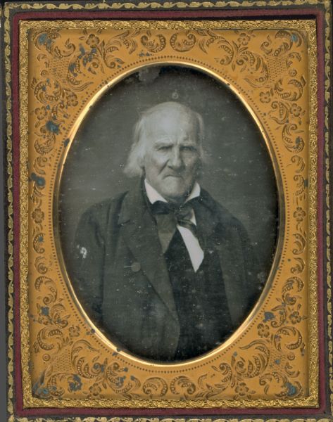 Quarter plate daguerreotype waist-up portrait of Adam Beatty Washington. He is wearing a suit, vest, and necktie. Hand-coloring on cheeks.