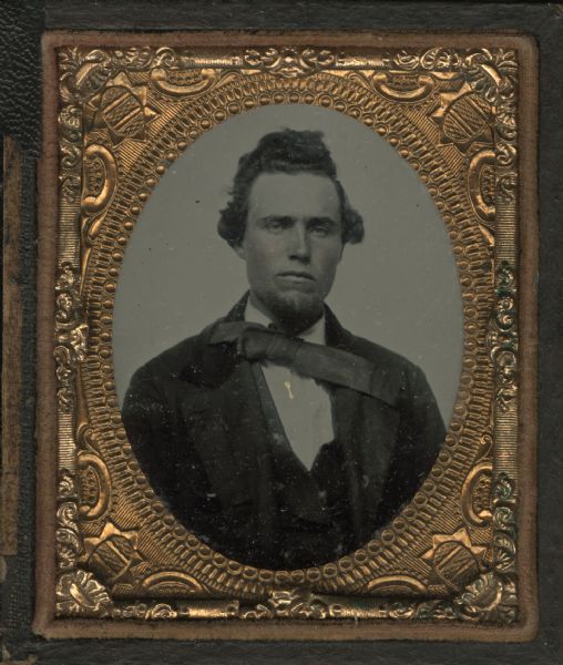 Ninth plate ambrotype of James L. Foley. Half figure facing front and slightly right, with goatee, wearing a coat and bow tie with long right tail laying across his left shoulder. Hand-coloring on cheeks; gold details on pin. Foley was an Irish farmer and resident of Wauwatosa, Wisconsin. He became Waukesha County Superintendent of Schools in 1865, and Waukesha County Treasurer in 1866. 