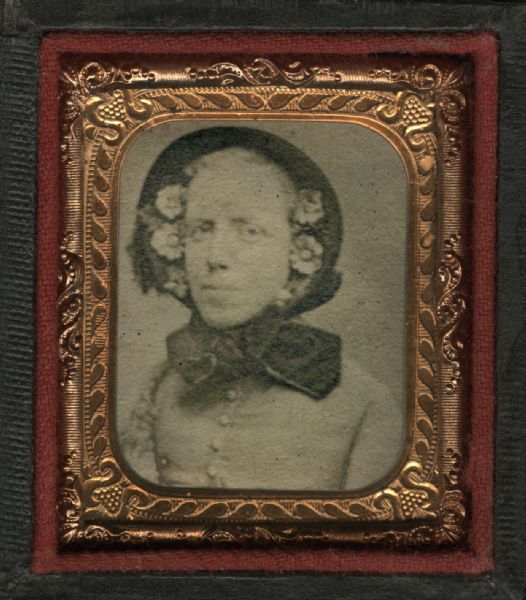 Cased albumen print of Mrs. Curtis, niece of Mary Oakley. Half figure facing front and slightly left, wearing bonnet with large tied bow and flowers lining both sides of face. 