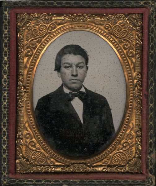 Ninth plate ambrotype of Spencer L. Case (1885-?).  Half figure facing front, wearing coat, vest, and tie. Hand-coloring on cheeks. 