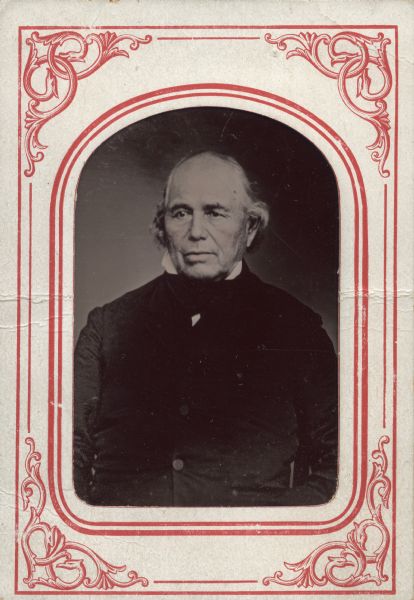 Ferrotype/tintype of Eleazer Williams (circa 1788-1858).  He faces slightly left and wears a dark suit with stand collar.  Cheeks and lower lip hand tinted. 
