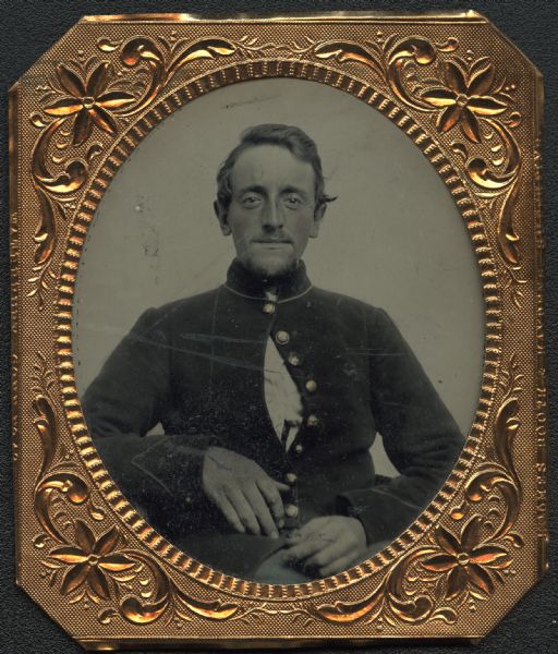 Sixth plate ferrotype/tintype of Alexander W. Collins in Civil War uniform, waist-up portrait, facing front. Top button and several lower buttons closed, cadet-style. Cheeks and buttons hand-colored. 