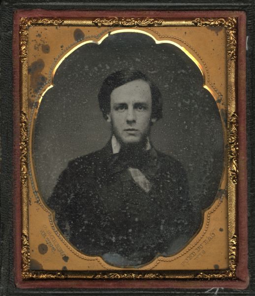 Sixth plate ferrotype/tintype of Augustus Ledyard Smith from Fond du Lac, Wisconsin. Quarter-length portrait, facing forward. He is wearing a suit and tie, and has a beard. 