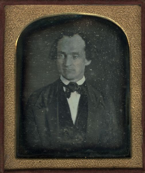 Quarter plate daguerreotype. Waist-up portrait of Darwin Clark, dressed in suit coat, waistcoat, and tie. Hand coloring on cheeks.