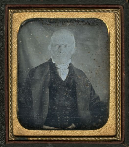 Sixth plate daguerreotype of Edward Beers, facing forward, wearing a suit and double-breasted plaid vest and checked tie, with stand collar. 
