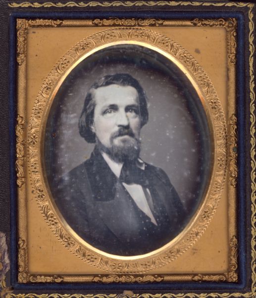 Sixth plate daguerreotype of Elisha Burdick (1822-1896), father of Mrs. William Snow Miller. One quarter length portrait with torso facing right and eyes facing front. He wears a suit with velvet collar and tie with collar turned down. Cheeks hand tinted. 
