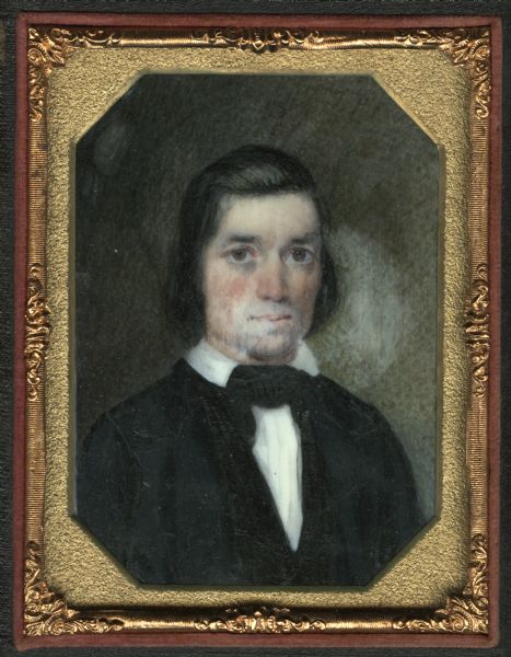 Painted miniature, possibly on ivory, of Wallace Mygatt. One quarter length portrait, facing forward, wearing a suit and collar turned down over tie. He has ruddy cheeks and what appears to be a slight goatee. 