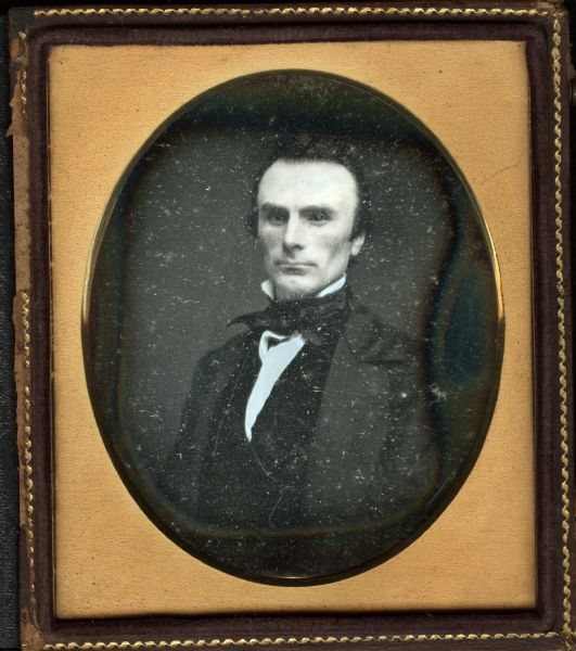 Sixth plate daguerreotype of Reverend Matthew Dinsdale. Quarter-length portrait facing forward, torso facing slightly left. He is wearing a suit and tie. 