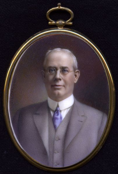 Cased miniature painting on ivory of William Henry Mylrea. Quarter length portrait, he is facing forward, wearing a suit and purple tie, and eyeglasses. 