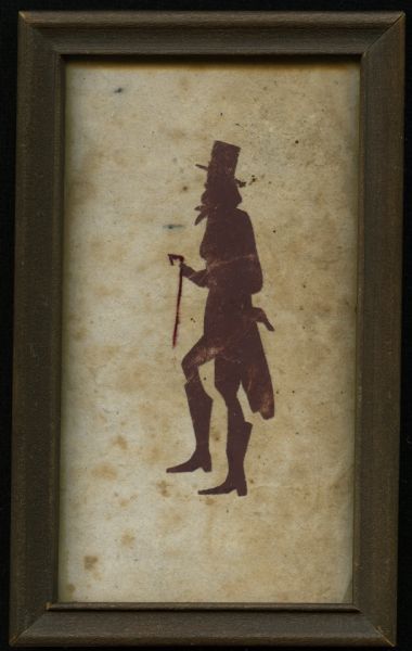 Paper cutout of the silhouette of a man wearing a hat, long suit coat, boots, and holding a cane. Paper on back of framed image reads: "Purchased in Madison Oct. 1927. In the back written in pencil it says John Randolph of Roanoke."