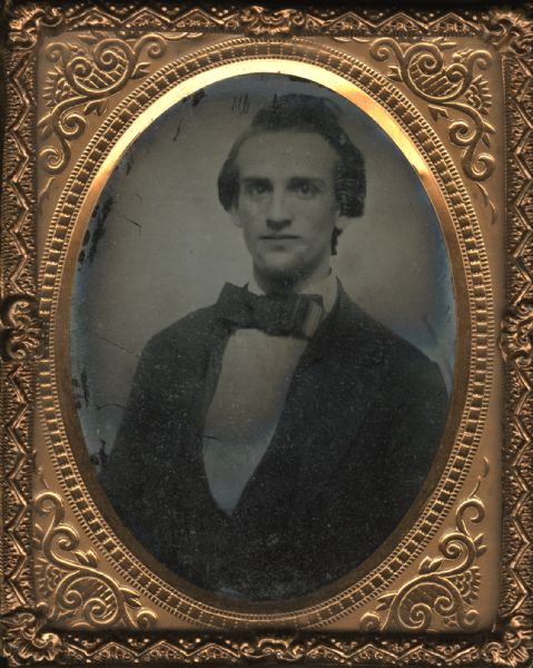 Ninth plate ambrotype quarter-length portrait of Mr. Ira Colby, a teacher of the Union School in Waukesha, Wisconsin. He has a beard and is wearing a suit and bow tie.