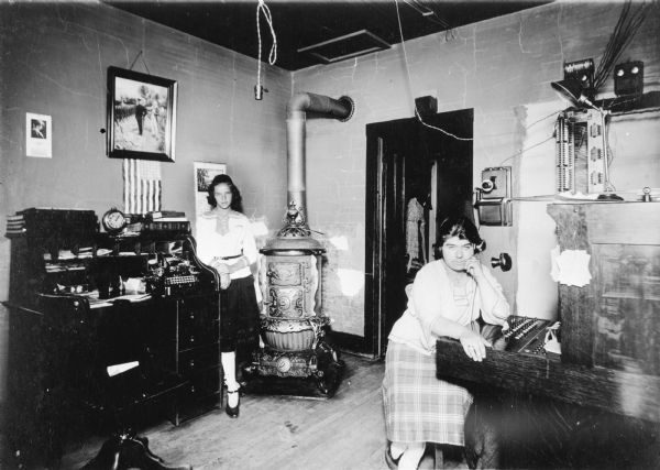 "This picture is of the first telephone exchange that I established in Laona. The girl standing is my youngest daughter. This exchange is still operated in Laona in the same room. This building belongs to the telephone company and was built by myself and a carpenter the year of 1907." Norman Johnson, Sr.