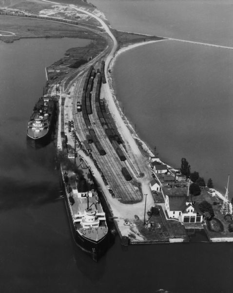 Aerial view of two Lake Michigan ferries tied up at harbor slips. The eastern terminus of the Green Bay Route was the Lake Michigan port city of Kewaunee. The railroad had a yard with two ferry slips, located on a peninsula jutting into the harbor.