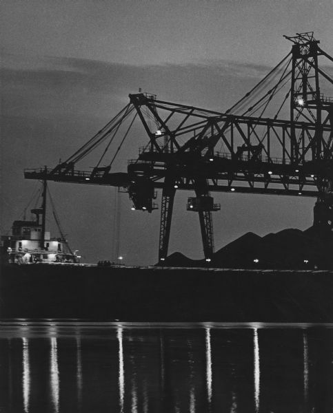 A night view of coal docks on a bay.