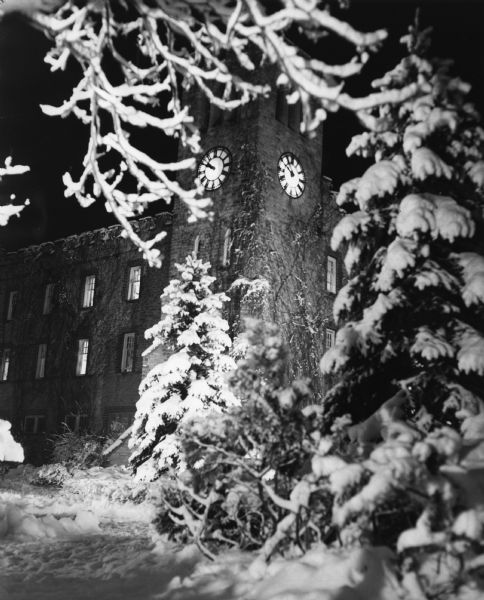 The clock tower at St. John's Military Academy, framed by snow-covered branches.