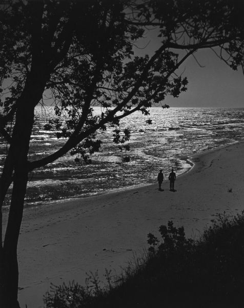 Elevated view of a two people strolling on Algoma Beach.
