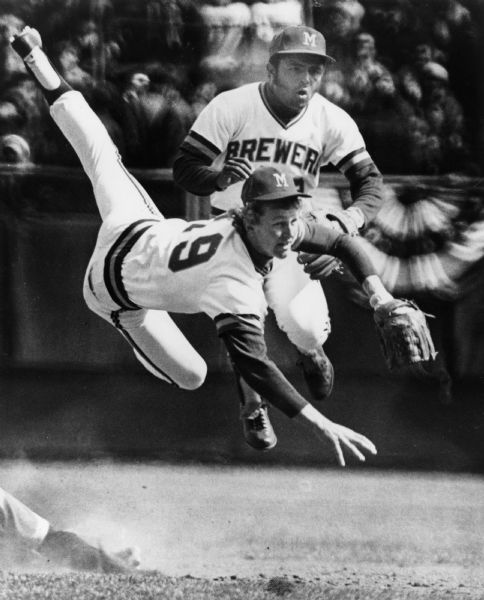 Two Milwaukee Brewer's baseball players colliding in midair. Player #19 is Robin Yount and the other player is second baseman Pedro Garcia.