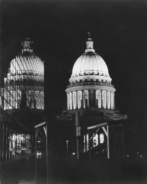 Reflection of the Wisconsin State Capitol at night in the U.S. Bank Plaza windows. The Plaza was built in 1973 and the original name was the First Wisconsin Bank.