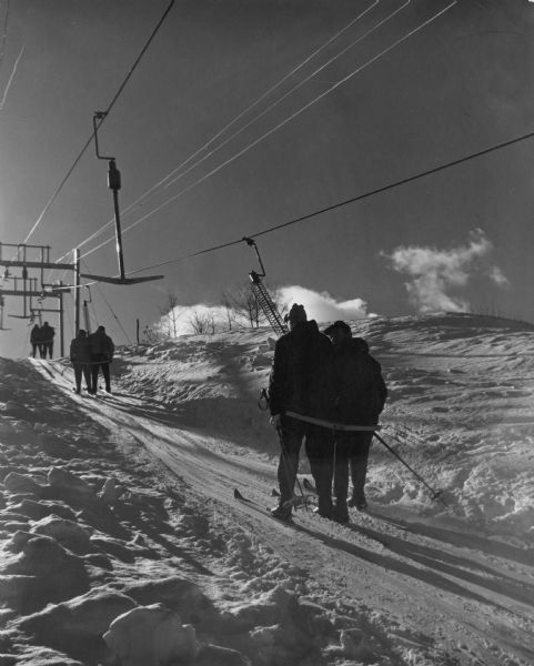 Skiers ascending Mt. Telemark on a T-Bar ski lift.