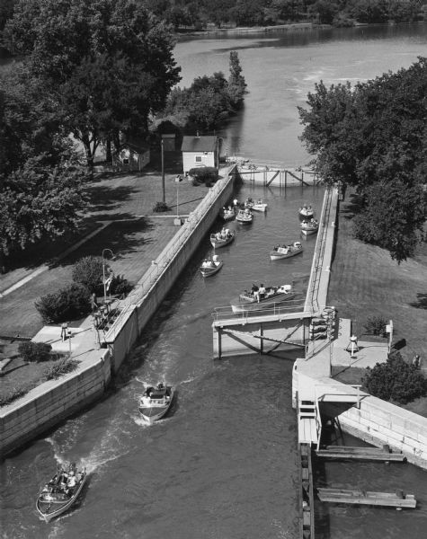 Elevated view from East College Avenue bridge of motor boats exiting Lock #4 on the Upper Fox River.