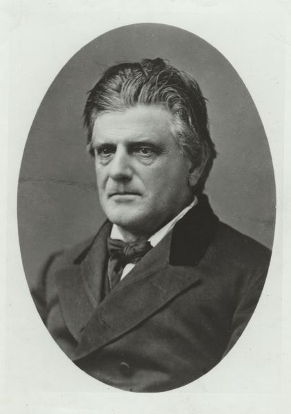 Quarter-length oval-framed portrait of Governor Nelson Dewey wearing a suit and neck tie.