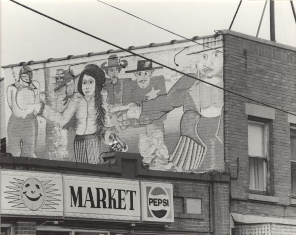 View from street of a mural on the side of the upper story of a brick building next to the Sunshine Market. Above the entrance to the market is a sign with a cartoon image of a sun, and signs that read: "Market" and "Pepsi."