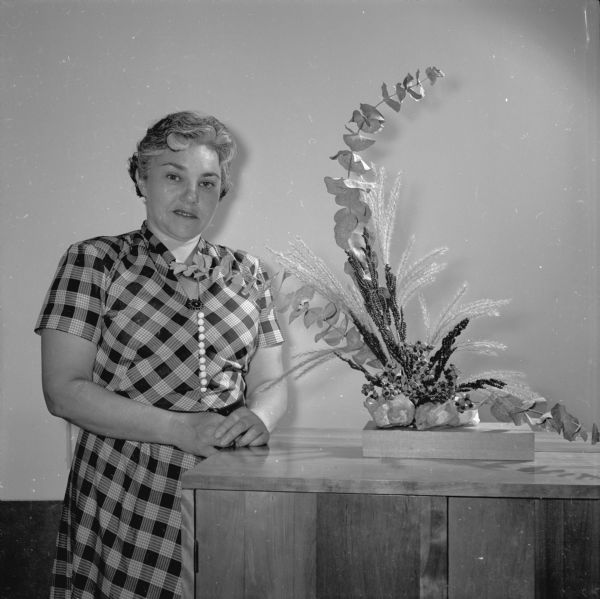 Mora Lincoln with one of her flower arrangements. She regularly gives lessons and demonstrations on the art of arranging flowers.