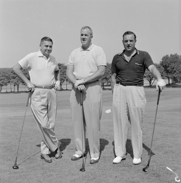 Group portrait of three men standing on a golf course. Among those pictured of a total of twelve negatives are: Walter Atwood, Steve Caravello, Jack Allen, Bill Garrott, Gene Koch, Frank Parkinson, John Stoneman, Harry Simonson.
