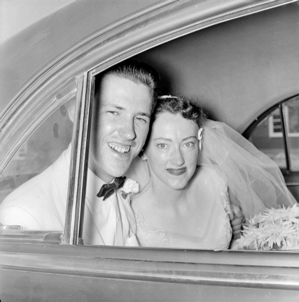Newlyweds Joan Marie Holm and Peter Byrd Smith in a car following the wedding service at First Baptist church.