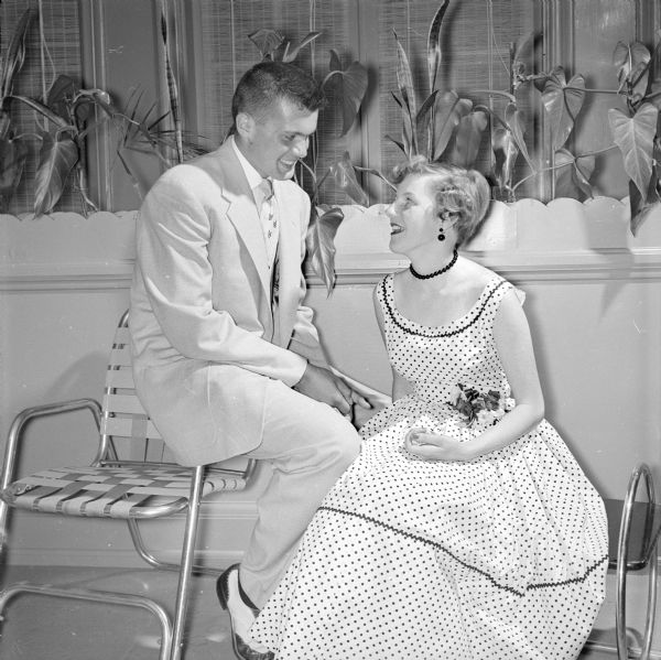 Teenagers Tom Stephan and Jean McFarlane, seated, shown chatting at the Maple Bluff Country Club party.