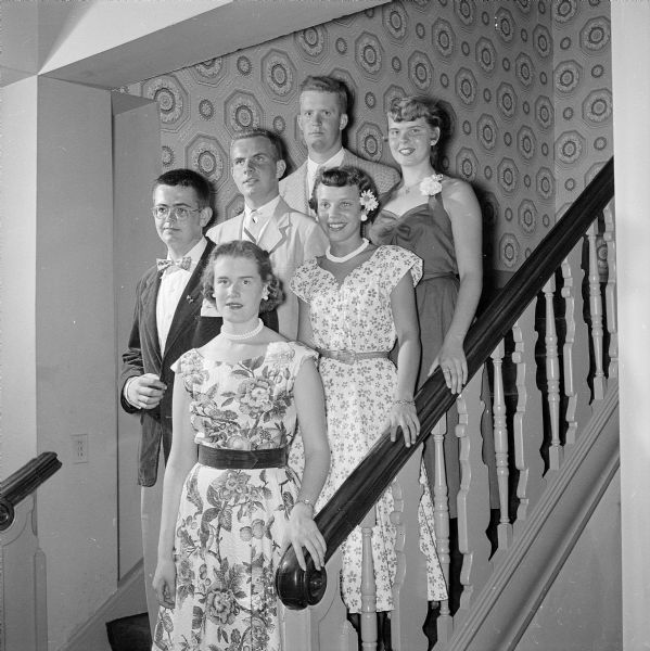 Three young couples posing on the stairs leading outside from the dance floor at the Maple Bluff Country Club. From front to back: Tom Tews and Dorothy Marling; Thomas Farley and Susan Edgerton; Joseph Irwin and Pat Moran.