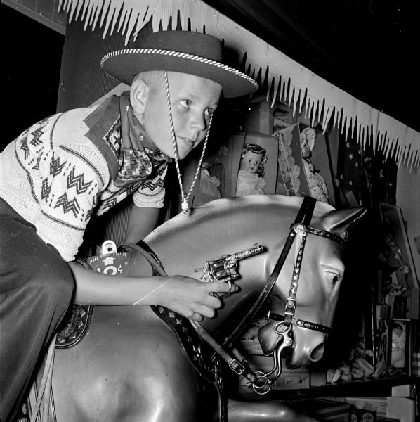 After Governor Kohler signed legislation legalizing the sale of caps and cap pistols, many youth prepared to celebrate the Independence Day holiday with the new toys. Pictured is Billy Adams of Forest Park riding a plaster horse.