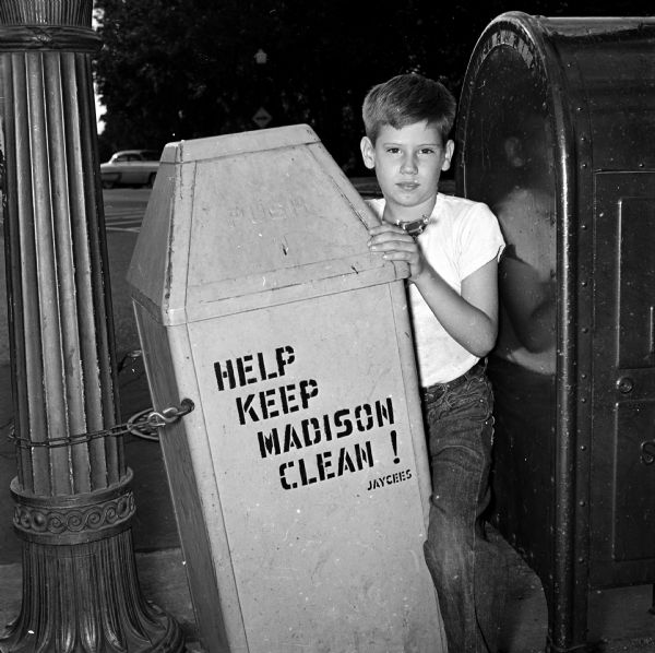 After Governor Kohler signed legislation legalizing the sale of caps and cap pistols, many youth prepared to celebrate the Independence Day holiday with the new toys. Pictured is Steven Harmening between a trash can and a mail box.