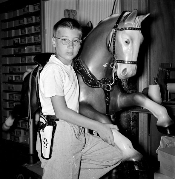 After Governor Kohler signed legislation legalizing the sale of caps and cap pistols, many youth prepared to celebrate the Independence Day holiday with the new toys. Pictured is Frederick Cobbs beside a plaster horse.