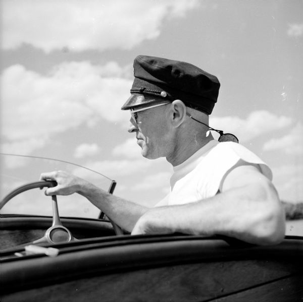 Ed Feiler sits at the wheel of his Falls Flyer "Fireball" boat on Monona Bay.